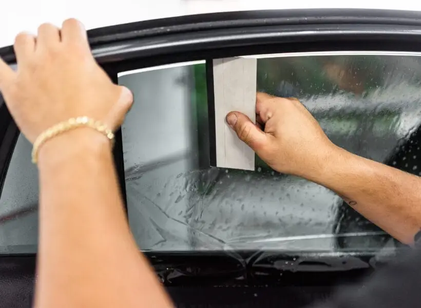 technician applying window tinting film