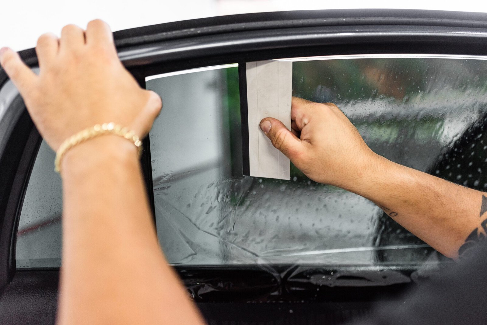 technician applying window tinting film